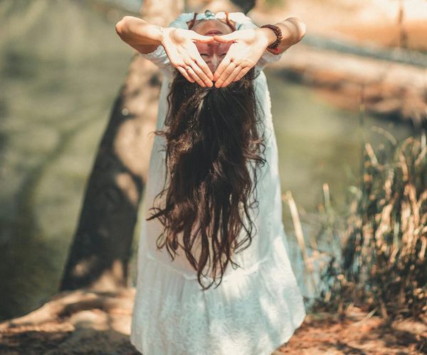 A serene person meditating in a calm natural environment.